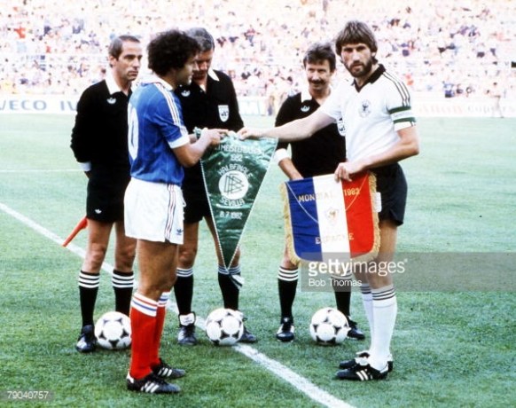 The captains and officials complete the preliminaries before the game.