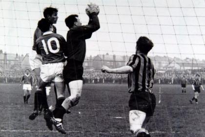 Wallace catches a cross in the game that defined the term 'shock reult' in Scottish folotball history.